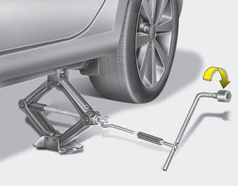 8. Insert the jack handle into the jack and turn it clockwise, raising the vehicle